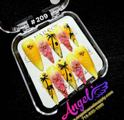 Decorative nail art set with palm tree designs in a clear case on a black background.